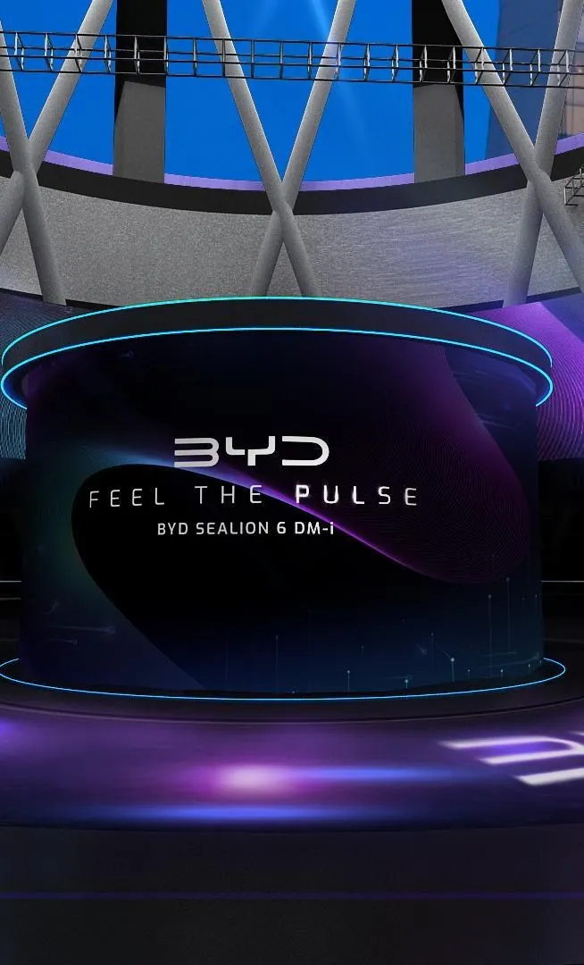 Feel The Pulse — Sealion 6 DM-i for BYD — Portal and halo study. The stage reads as a single lit aperture from the seating bank.